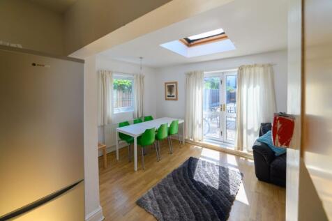 Bright and inviting living room with ample natu...