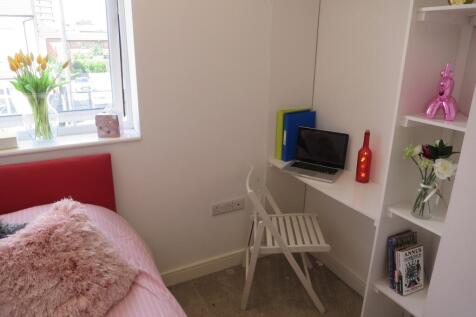 A bright and inviting double bedroom featuring ...