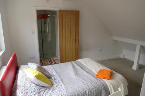 A bright and inviting double bedroom featuring ...