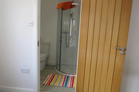 A bright and modern bathroom with a stylish sho...