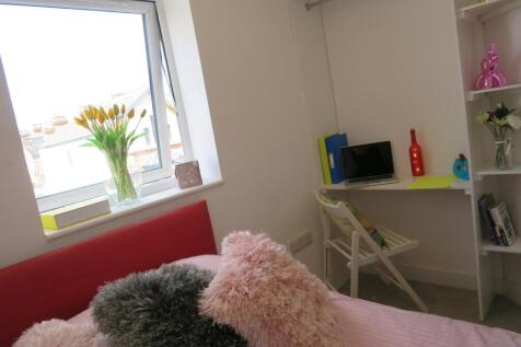 A bright and inviting double bedroom featuring ...