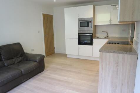 Bright open-plan living area with modern fitted...