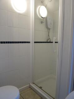 Clean and functional bathroom featuring a showe...