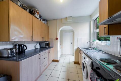 A well-lit, tidy kitchen featuring wooden cabin...