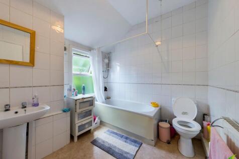 Bright and functional bathroom featuring a bath...