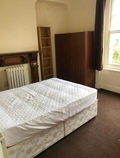 A double bedroom with a bed, wardrobe, and radi...