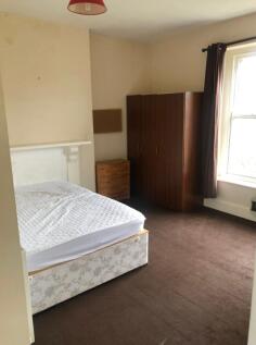 A tidy double bedroom featuring a bed and wardr...