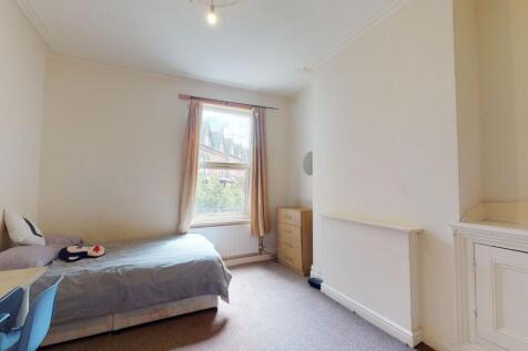 A bright and cozy bedroom featuring a single be...