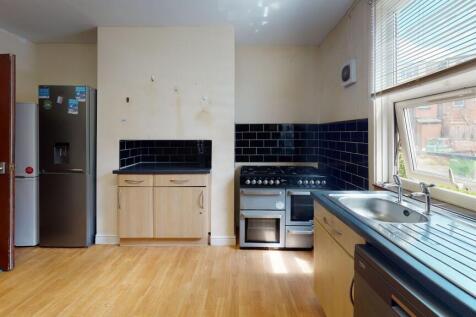 Bright and cozy kitchen featuring a large windo...