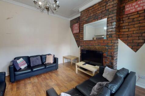 Spacious and modern living room featuring a str...