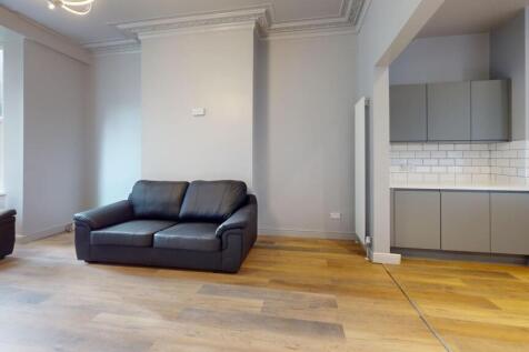 Bright and modern living room featuring large w...