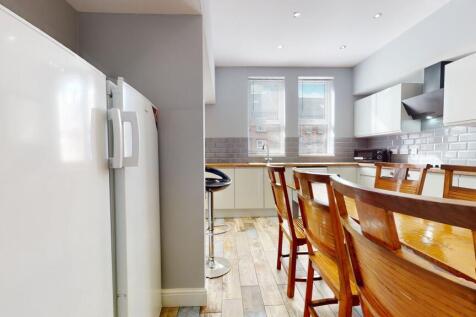 Bright and modern kitchen with ample natural li...