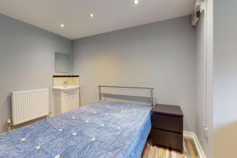 A compact bathroom featuring a small sink with ...