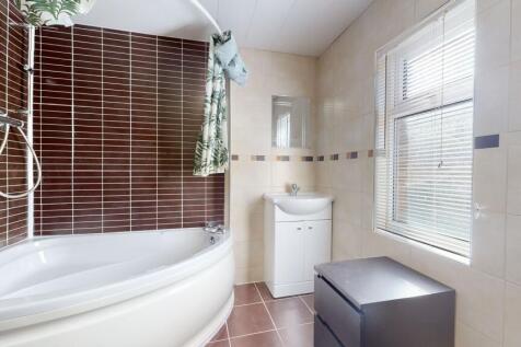 Bright and modern bathroom featuring a large ba...