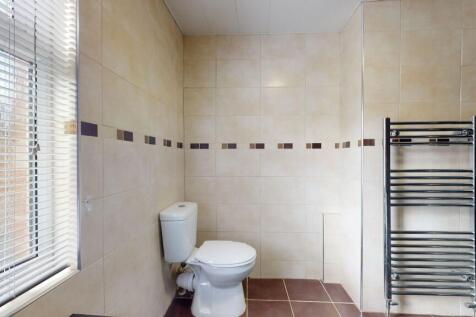 Bright and clean bathroom with a large window, ...