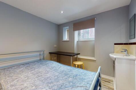 Bright and cozy double bedroom featuring a meta...