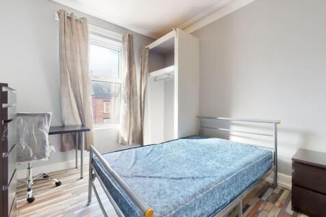 Bright and airy single bedroom featuring a wind...