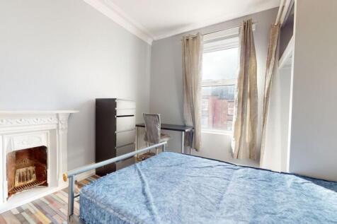 Bright and welcoming bedroom with a large windo...
