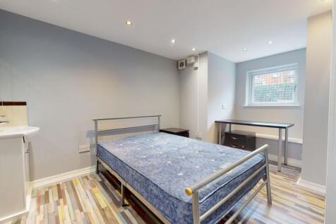 Bright and tidy bedroom featuring a comfortable...