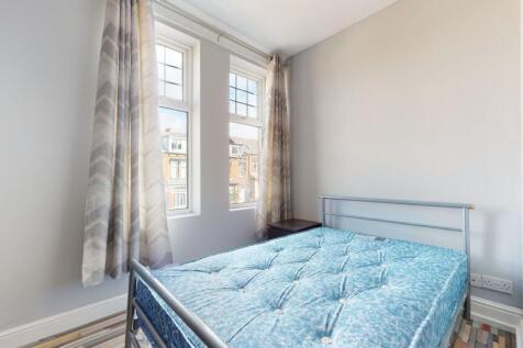 Bright and airy bedroom featuring large windows...