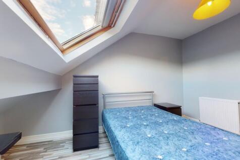 A bright and airy bedroom featuring a skylight ...