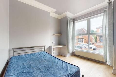 Bright and airy bedroom with a large window off...