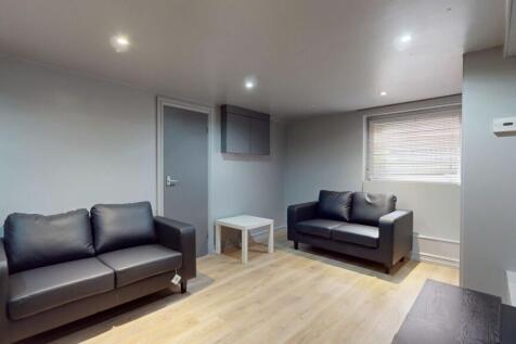 Spacious and modern living room featuring two c...