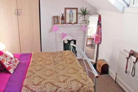 Bright, neatly styled double bedroom with patte...