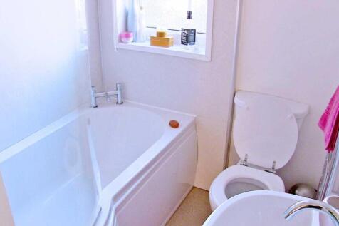Bright, well-kept bathroom with a modern white ...