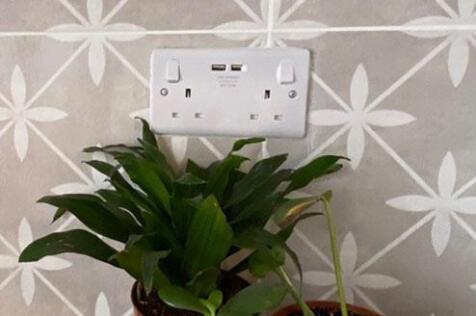 Close-up of a stylish wall socket set against p...