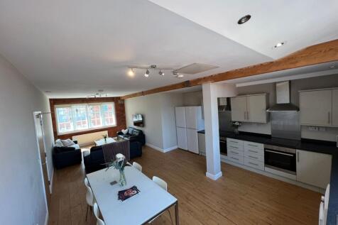 A spacious and bright living room featuring lar...