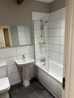 A clean and modern bathroom featuring a large b...