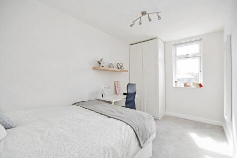 Bright and airy master bedroom with a large bed...