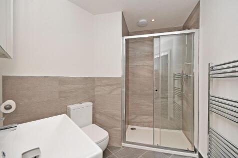 Modern bathroom featuring a walk-in shower with...