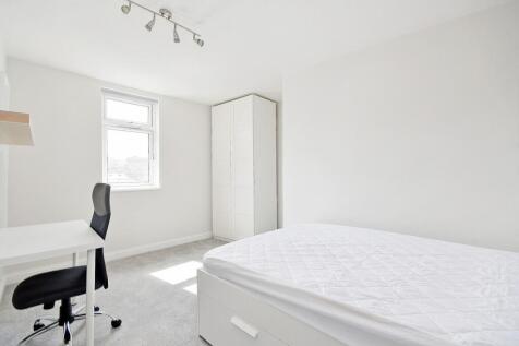 Bright, spacious master bedroom with a large be...