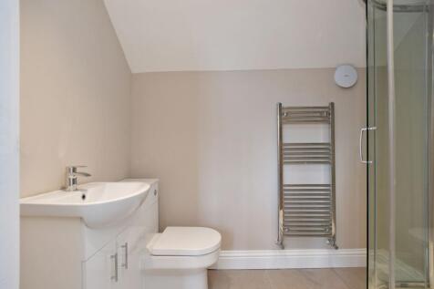 A modern bathroom featuring a white sink with a...