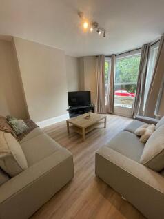 Bright and inviting living room with large bay ...