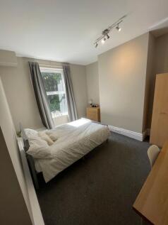 A bright and clean double bedroom with a large ...
