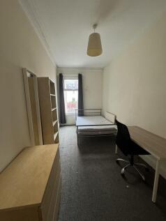 A well-lit, tidy living space featuring a large...