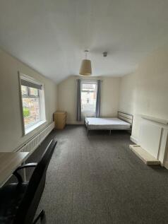 A spacious, well-lit living room with two large...