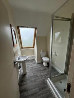 Bright and clean bathroom featuring a window sk...