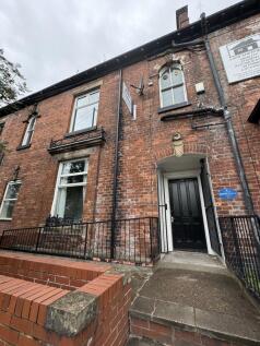 The exterior front view of a traditional brick ...