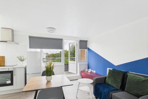 Bright, modern open-plan living area with a com...