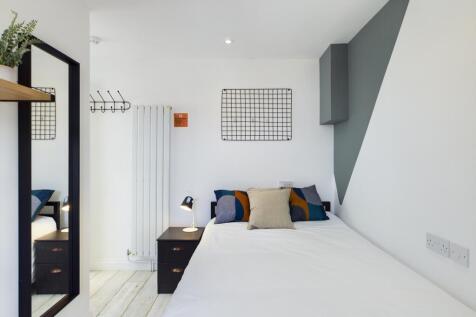 A bright and stylish double bedroom featuring m...