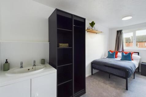 A bright and spacious double bedroom featuring ...