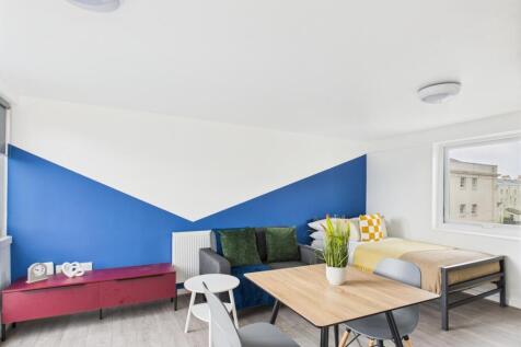 Bright, modern living room with bold geometric ...