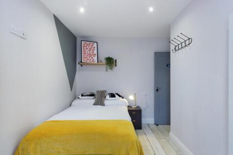 A bright and inviting double bedroom, featuring...