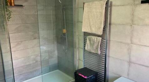 A clean and bright bathroom with a modern showe...