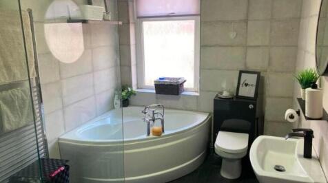 A clean and modern bathroom featuring a large b...