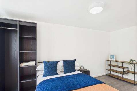 Bright, neatly presented bedroom with a comfort...